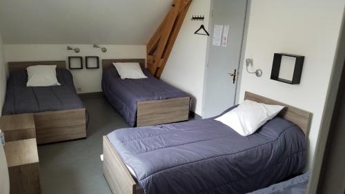 a room with two beds in a room at Auberge Saint Jacques in Saint-Alban-sur-Limagnole