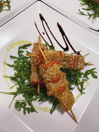 a white plate topped with food on top of greens at Wellness Villa Istriana in Umag