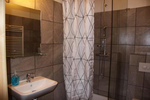 a bathroom with a sink and a shower at Cabin 2 at Lundar Farm in Varmaland