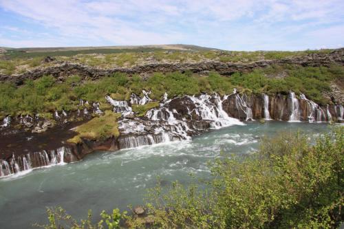 a waterfall in the middle of a river at Cabin 2 at Lundar Farm in Varmaland