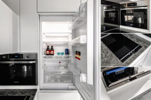 a refrigerator with its door open with drinks in it at PLATiNIUM RESIDENCE&SPA BASEN-SAUNA "BEST VIEW" CENTER in Lublin