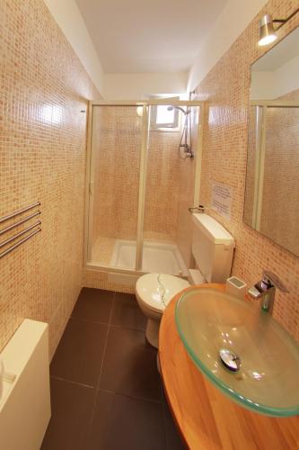 a bathroom with a sink and a toilet and a shower at B&B Sbarco dei 1000 in Marsala