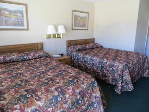 A bed or beds in a room at Budget Inn Denison