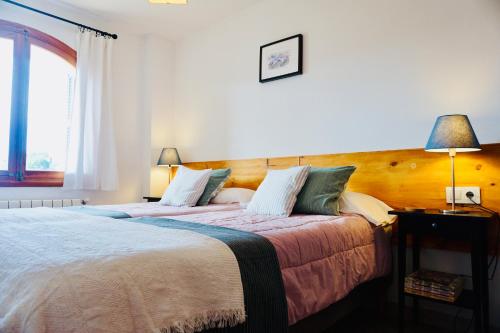 een slaapkamer met 2 bedden en een raam bij Alojamiento Migjorn in Sóller