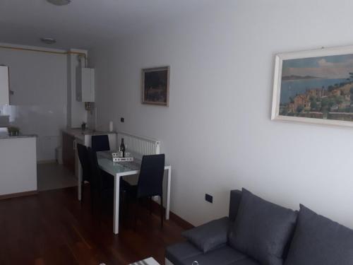 a living room with a table and a couch at Pleasing place in Fažana