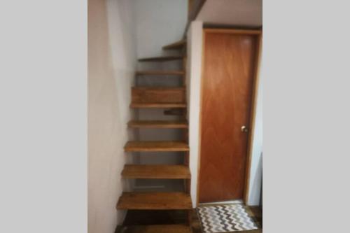 a staircase in a room with a laptop on it at Parrot House San Antonio in Cali