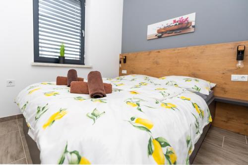 a bedroom with a bed with stuffed animals on it at Apartments Sunrise Banovci in Banovci