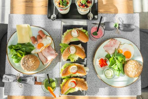 four plates with different types of food on a table at Apartments Sunrise Banovci in Banovci