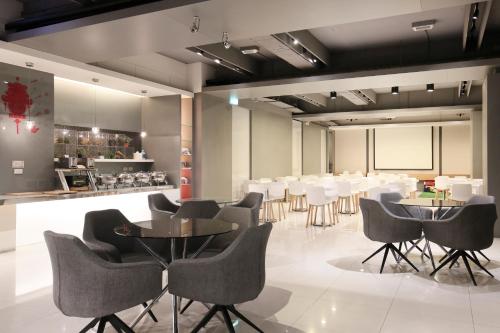 a conference room with chairs and tables and a bar at Dandy Hotel-Daan Park Branch in Taipei