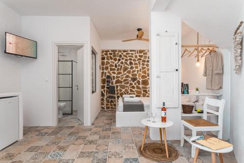 a room with a bathroom with a bed and a table at SeaView Apartment & Studio in Psili Ammos