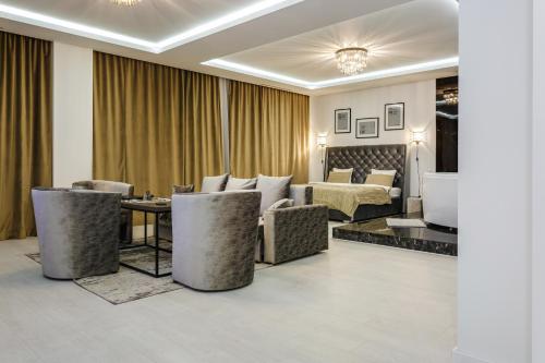a hotel room with a bed and a living room at Апартаменты Гостиный Дом in Minsk