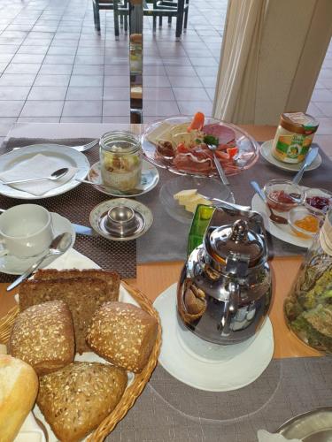 a table topped with plates of food and bread at Hotel Sonnenhof in Lügde