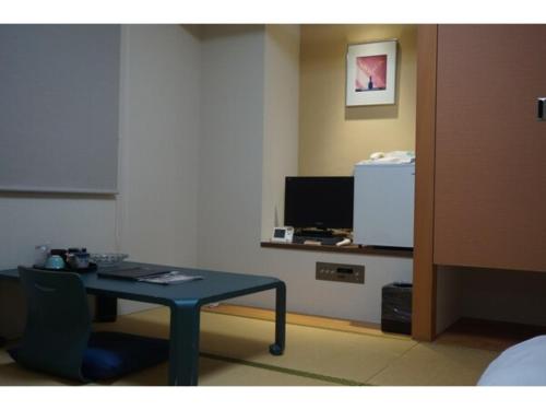 a room with a table and a tv in a room at Plaza Arakawaoki - Vacation STAY 24681v in Tsuchiura