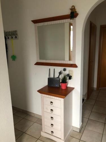 a bathroom with a dresser and a mirror at Ferienhaus Ahrensmoor in Ahlerstedt