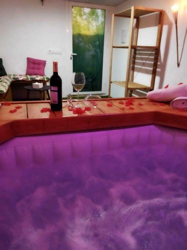 a bottle of wine sitting next to a swimming pool at Casa Capricho in Vejer de la Frontera