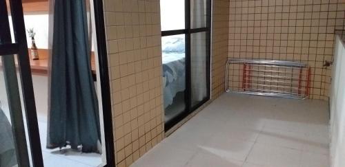 an empty room with a window and a cage at Cobertura Climatizada, Spa no litoral in Cabo Frio