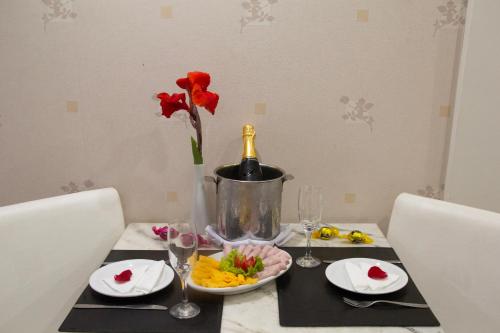 a table with a bottle of champagne and a plate of food at Bahiamar Hotel in Salvador