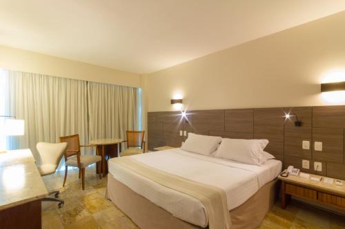 a hotel room with a bed and a table at Hotel Atlante Plaza in Recife