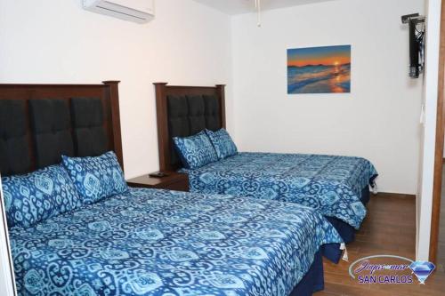Ένα ή περισσότερα κρεβάτια σε δωμάτιο στο Departamento Topacio 2 Joyas del mar San Carlos