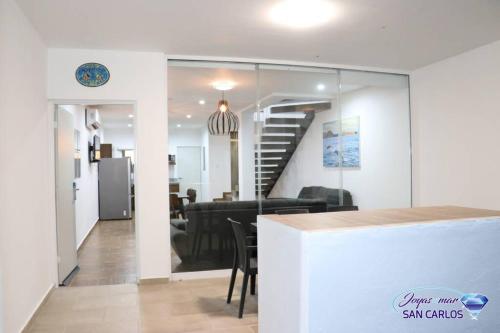 a living room with a staircase and a dining room at Departamento Topacio 2 Joyas del mar San Carlos in San Carlos