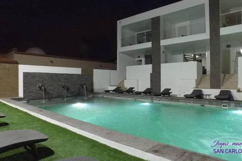 a swimming pool in a building at night at Departamento Topacio 3 Joyas del Mar San Carlos in San Carlos