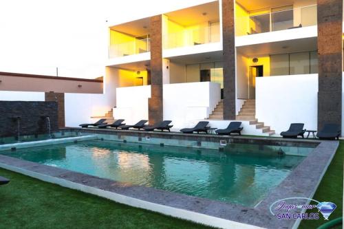 a swimming pool in front of a building at Departamento Topacio 3 Joyas del Mar San Carlos in San Carlos