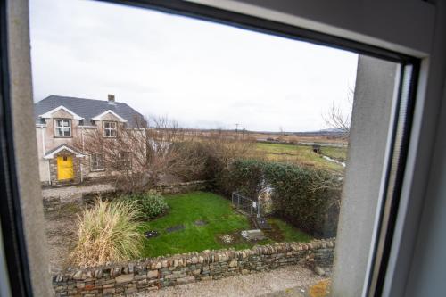 a view of a yard from a window at Beautiful coastal house at the Drowes Rivermouth in Bundoran