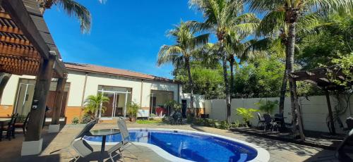 a backyard with a swimming pool and a house at Comfort Inn Real San Miguel in San Miguel