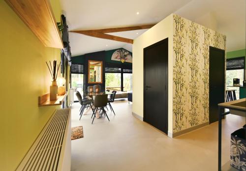 a hallway with a door leading to a dining room at ZEN-bungalow NO 1 met sauna en hottub in Rheezerveen