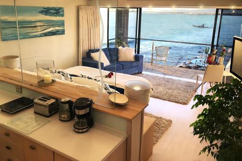 a hotel room with a view of the ocean at 185 on BEACH Boutique Suites in Gordonʼs Bay