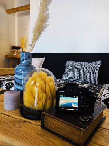 a camera sitting on top of a table next to a bed at Spongia Apartments Kalymnos in Kalymnos