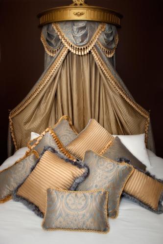 a bed with a canopy with pillows on it at The Castle on Tamborine in Mount Tamborine