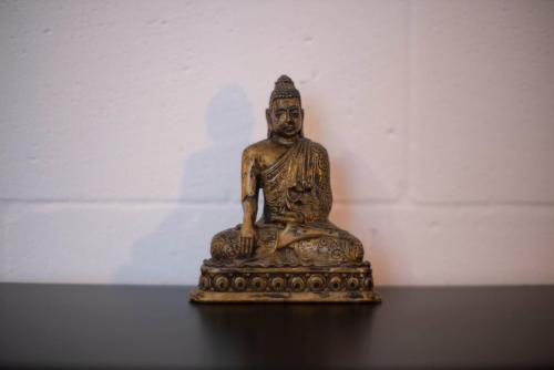 a bronze statue sitting on top of a table at 87029house in Scalea