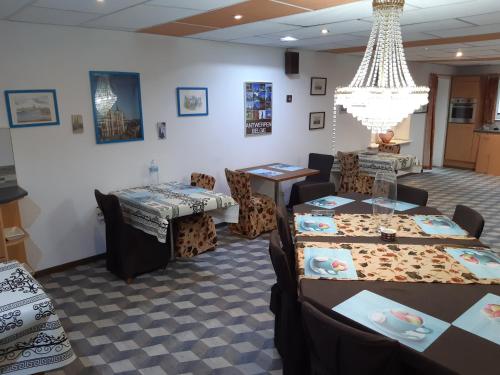 a dining room with tables and chairs and a chandelier at CASA DI MARCO in Antwerp