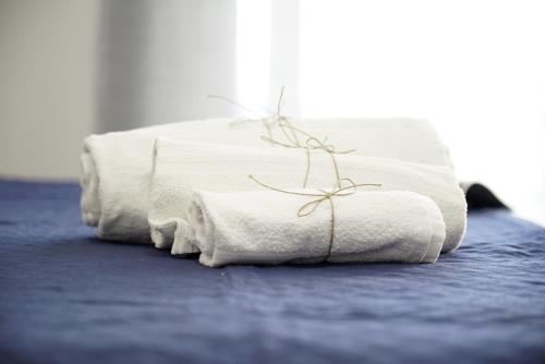 a couple of towels sitting on top of a bed at 87029house in Scalea