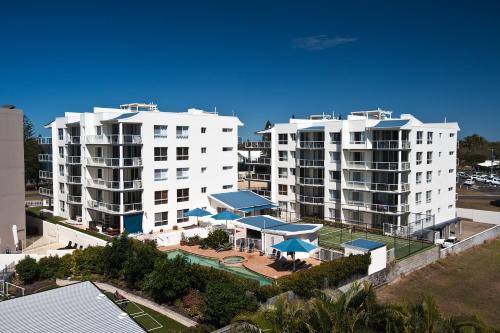 an aerial view of two white apartment buildings at Bargara Blue Resort in Bargara