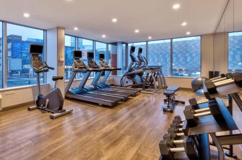 a gym with treadmills and exercise equipment in a building at Holiday Inn Express & Suites Jersey City - Holland Tunnel by IHG in Jersey City