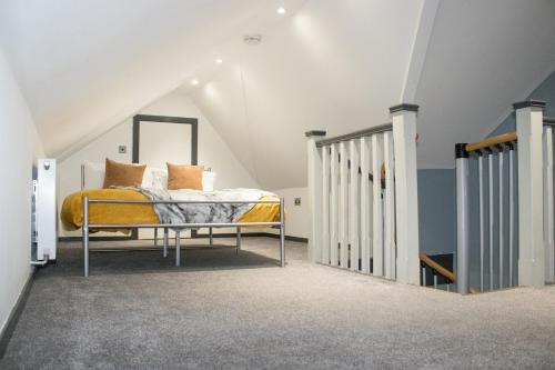 a bedroom with a bed in a attic at The Countryman Hideaway - Funky Loft Room in Gillingham