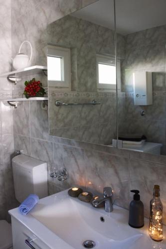 a bathroom with a sink and a mirror at Selce Holiday in Selce
