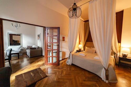 a bedroom with a bed and a living room at Lounge Apartments in Kraków