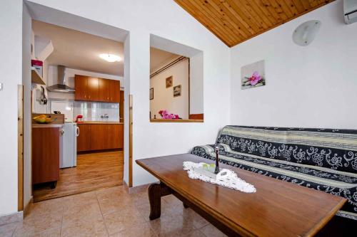 a living room with a couch and a wooden table at Apartment in Rovinj/Istrien 11562 in Štanga