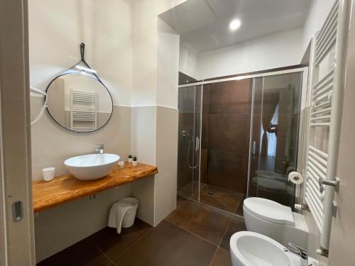 a bathroom with a toilet and a sink and a shower at Relais Petruzzelli in Bari
