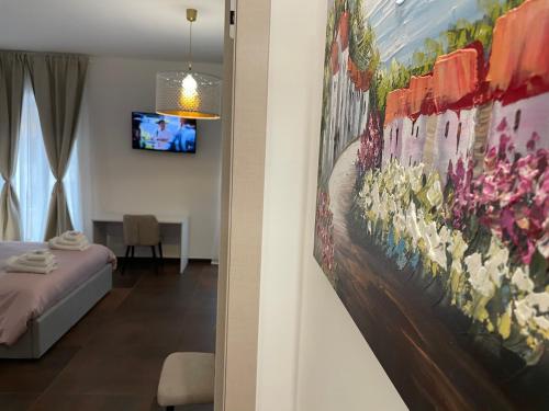 a bedroom with a painting of flowers on the wall at Relais Petruzzelli in Bari