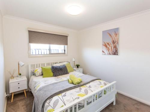 a bedroom with a bed and a window at Jindalee 3 34 Twynam St in Jindabyne