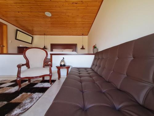 a living room with a couch and a chair at ReLuna Guatavita Glamping & Suites in Guatavita