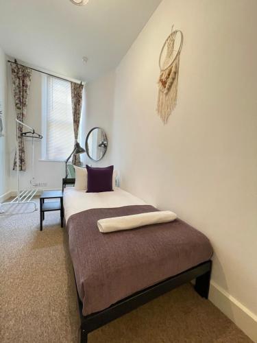 a bedroom with a bed and a mirror on the wall at Central Located Two Bedroom Suite in Bristol