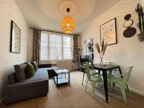 a living room with a couch and a table at Central Located Two Bedroom Suite in Bristol