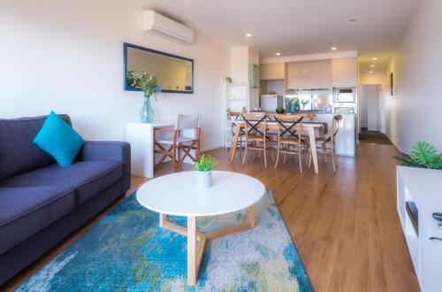 a living room with a couch and a table at Waterfront Apartments Marinaquays -Apt 221 and Apt 234 in Werribee South
