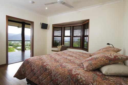 a bedroom with a large bed and a balcony at The Summit Bed & Breakfast in Atherton