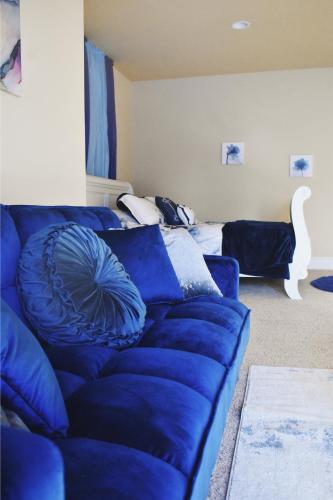 a blue couch in a living room with a bed at Villa Luna in Gig Harbor